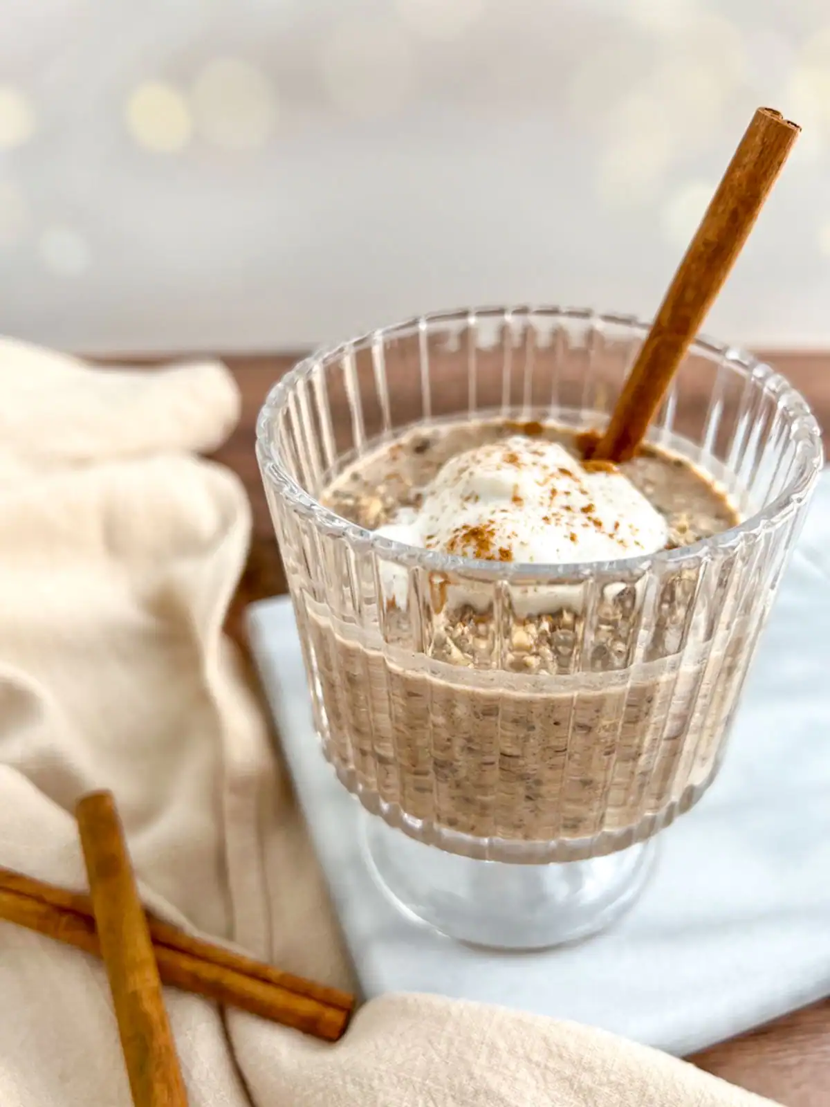 Chai spice overnight oats in a vintage glass.