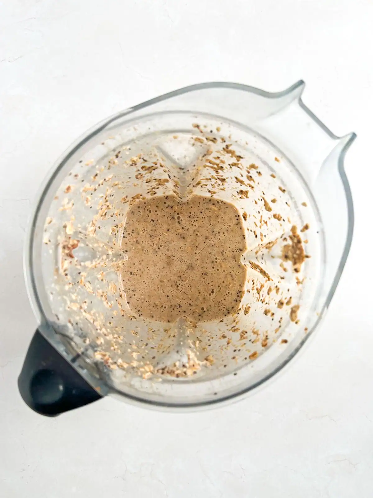 Ingredients for chai spice overnight oats mixed in a blender.