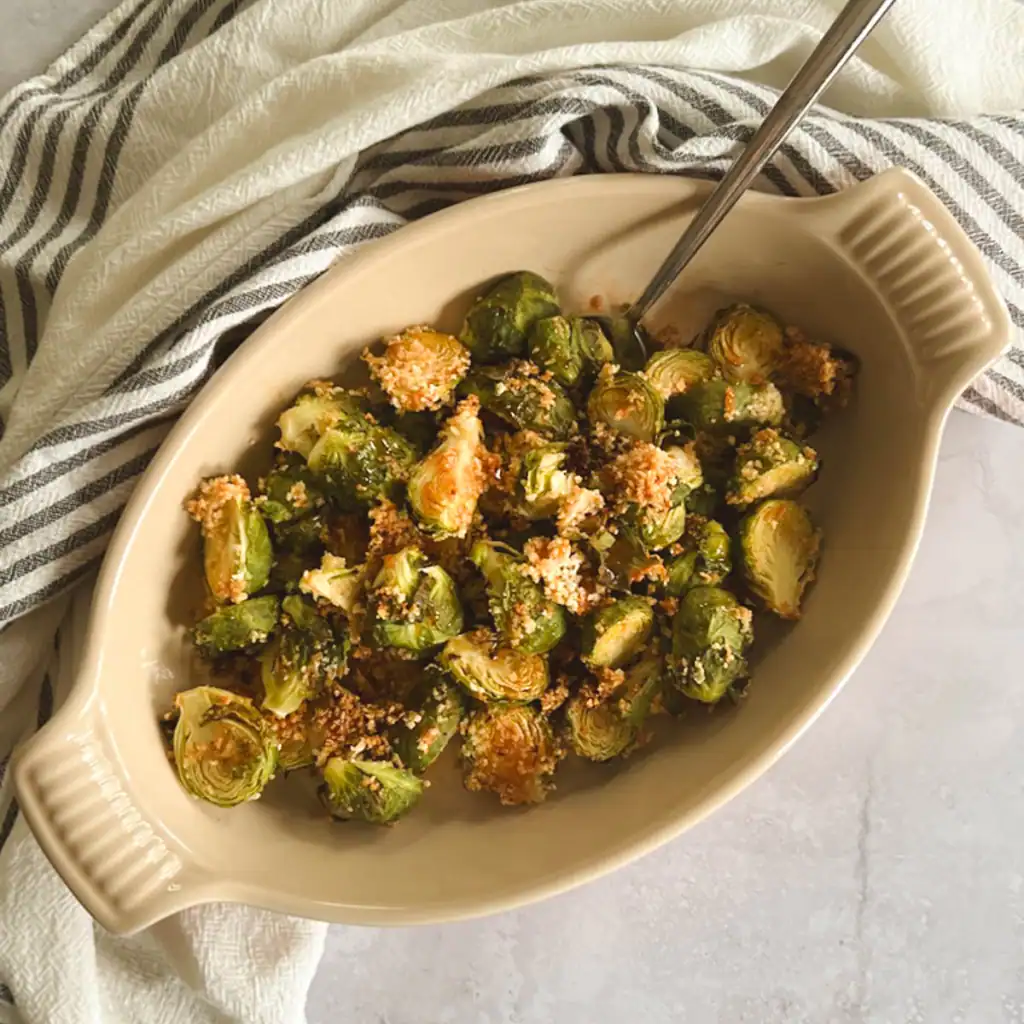 Crispy Brussels sprouts with spicy maple syrup in a serving dish.