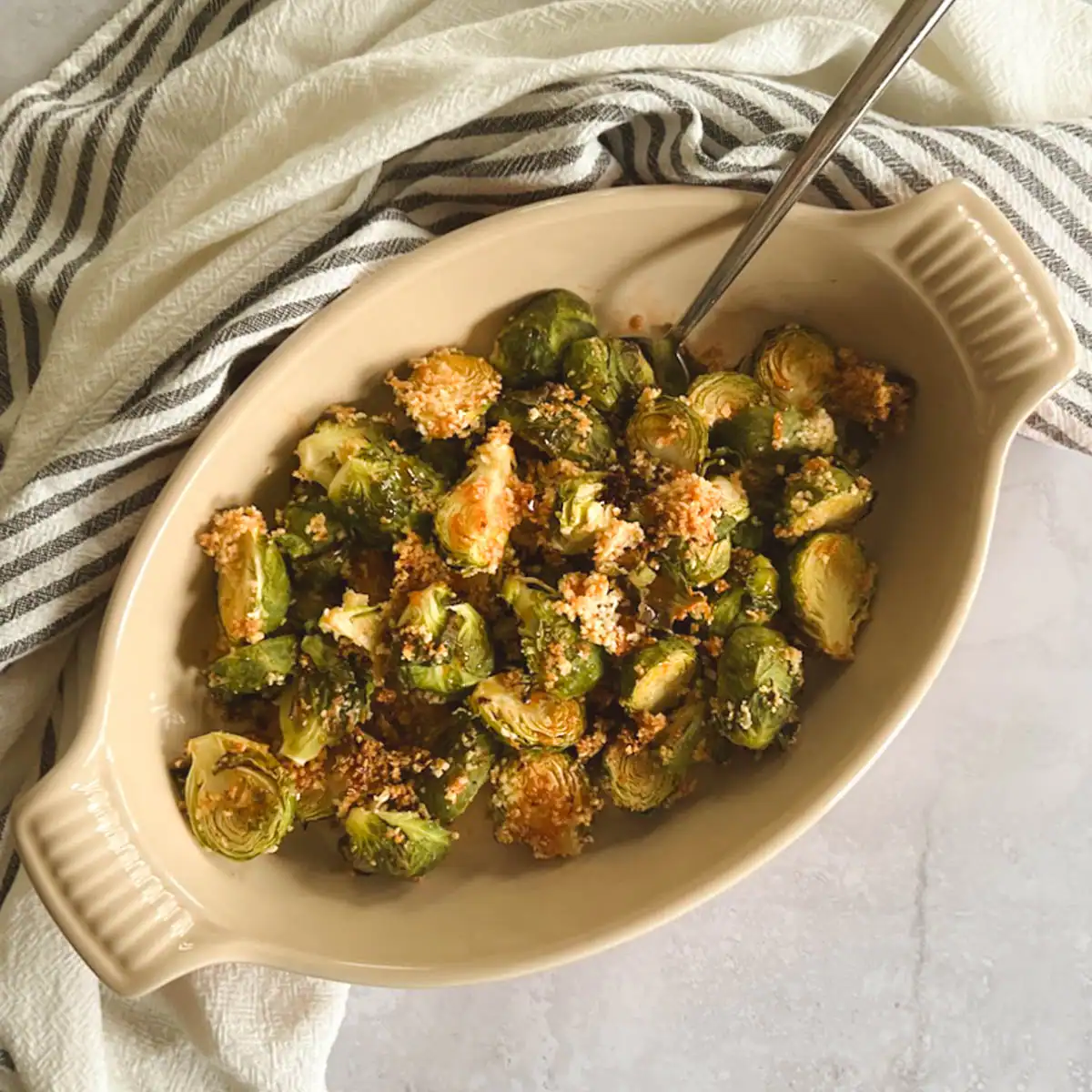 Crispy Brussels sprouts with spicy maple syrup in a serving dish.