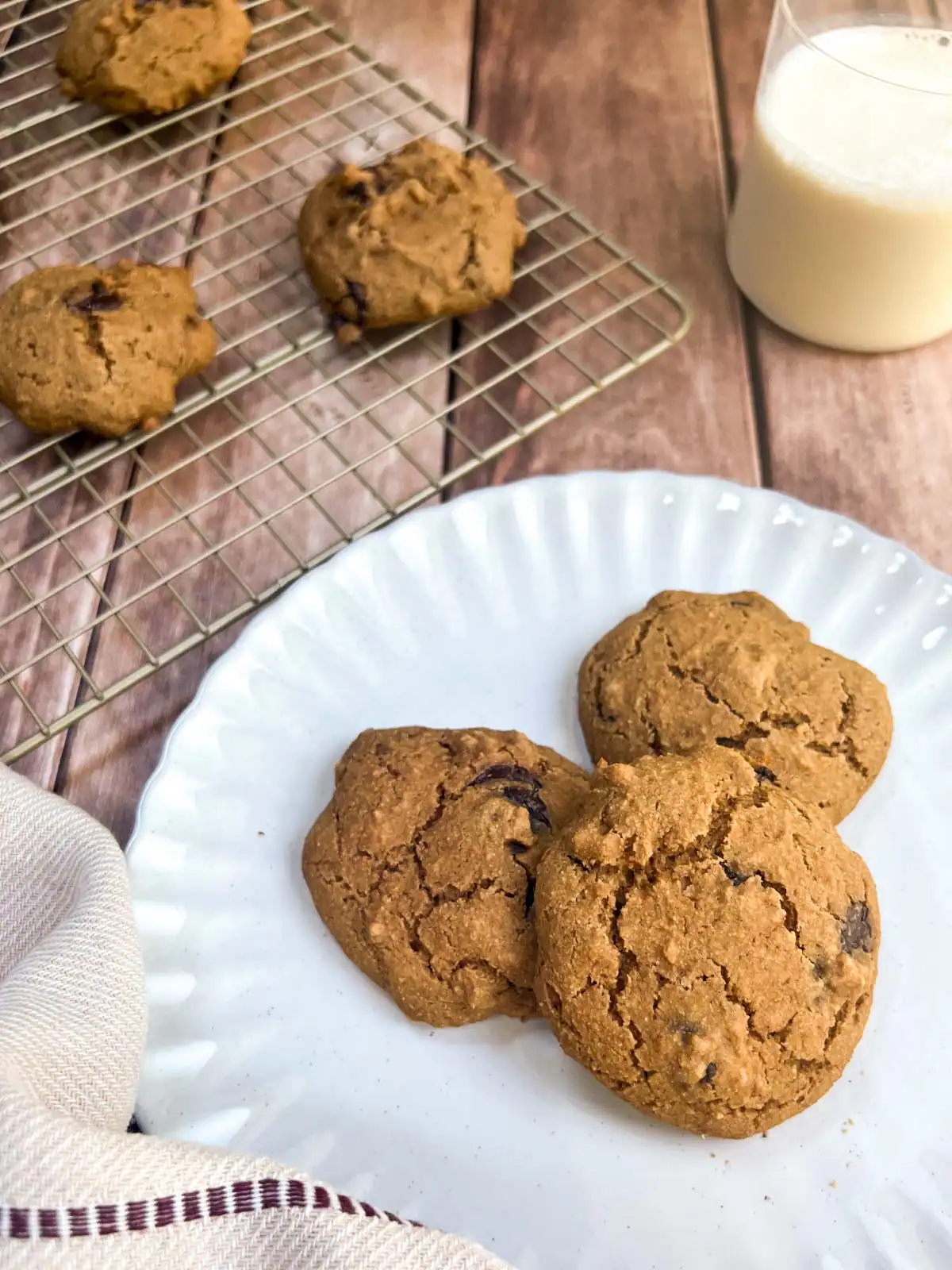 Fresh vegan chocolate chip cookies served on a white plate.