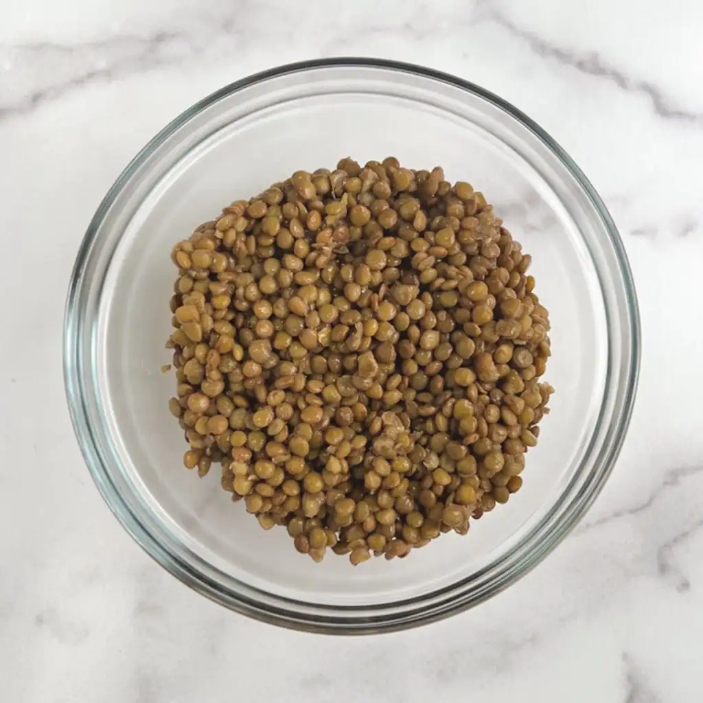 Cooked lentils in a glass bowl.