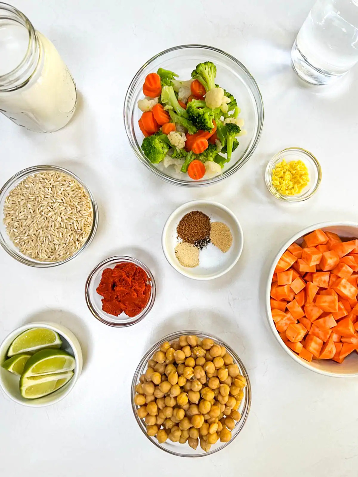 Ingredients for vegan Instant Pot red curry including chickpeas, rice, carrots, broccoli, and spices.