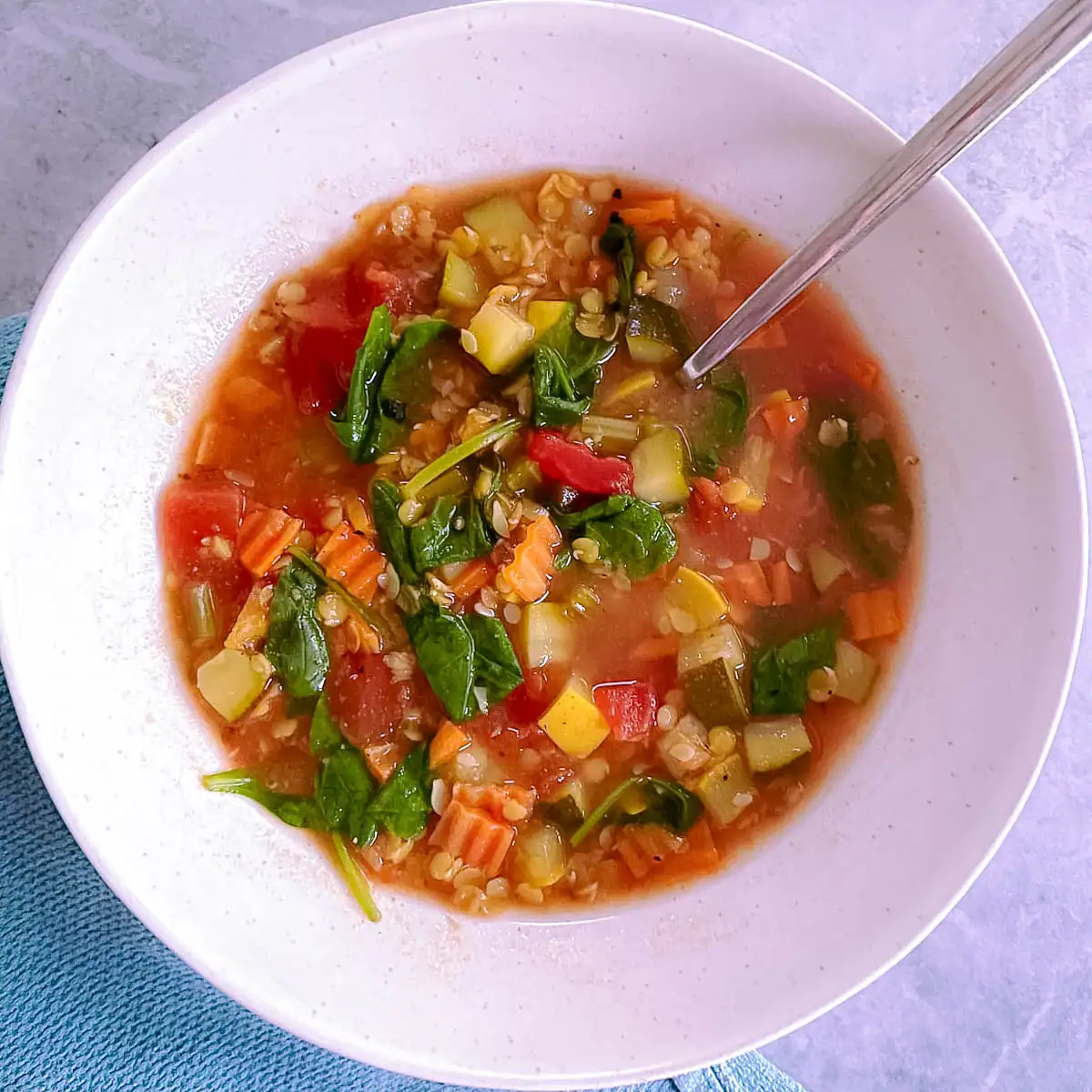 Red lentil minestrone soup in a bowl.