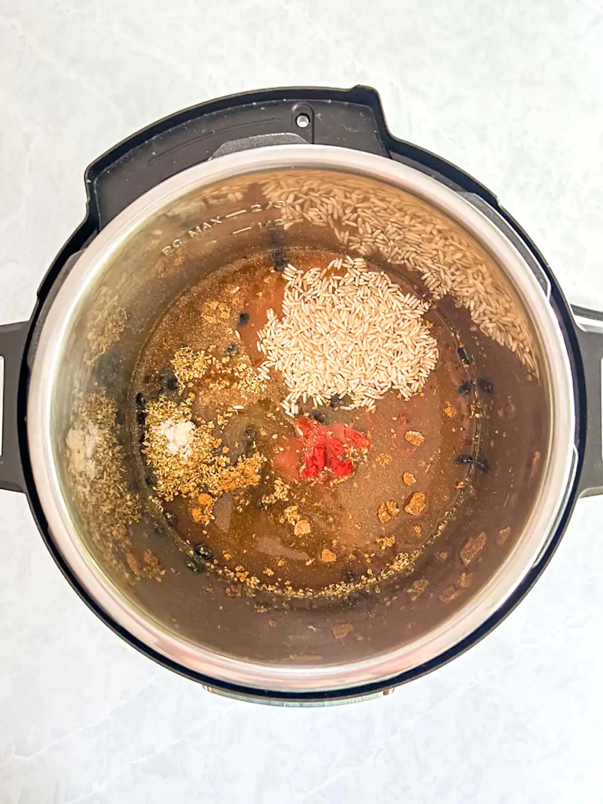 Ingredients for vegan black beans and rice in an Instant Pot.