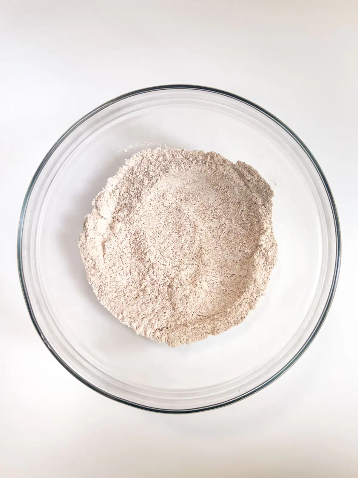 Dry ingredients for gluten-free vegan chocolate chips cookies in a glass bowl.