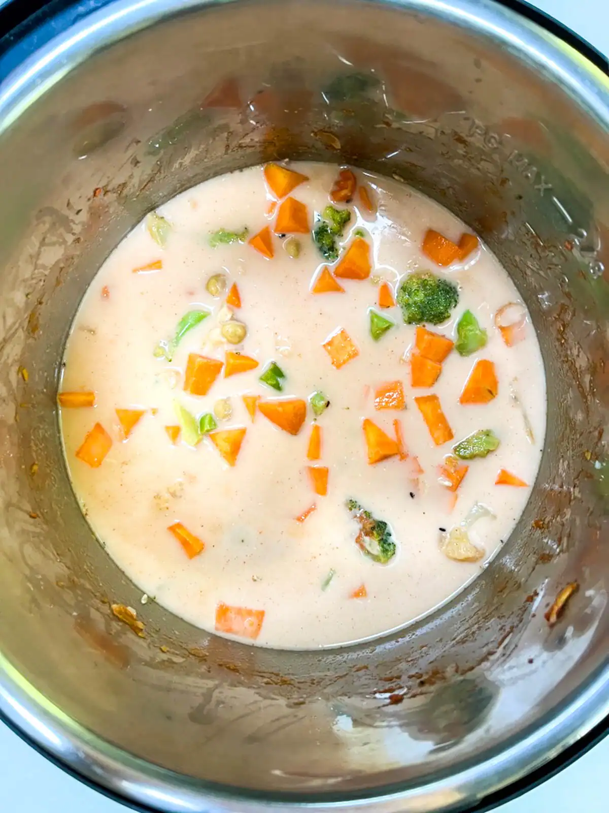 Ingredients for red curry in Instant Pot with liquids added.