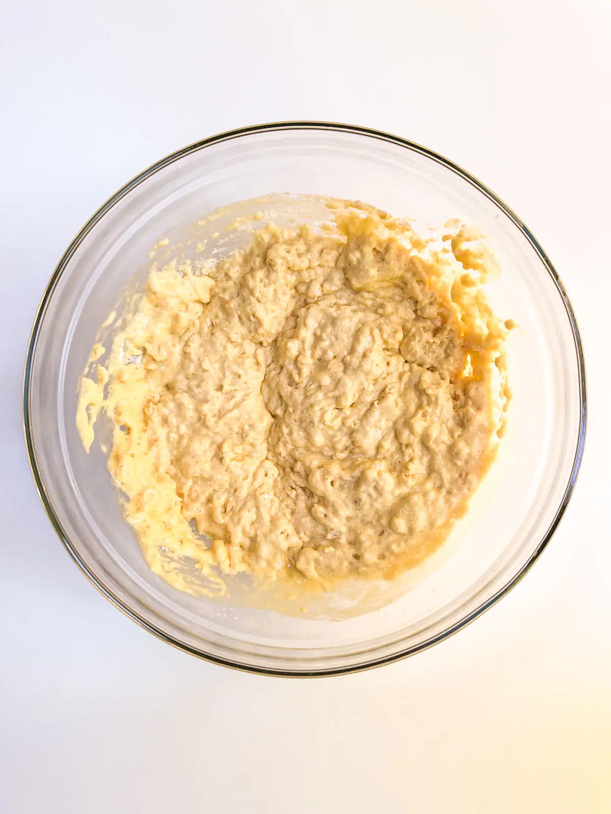 Batter for vegan orange muffins in a glass bowl.