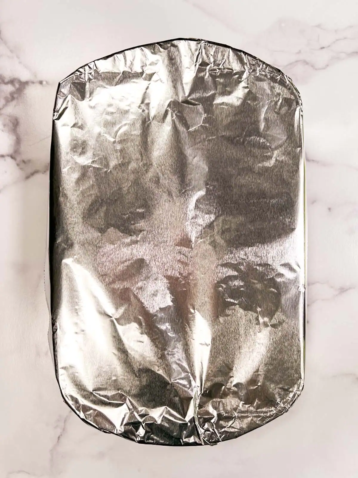 Aluminum foil-wrapped casserole dish.