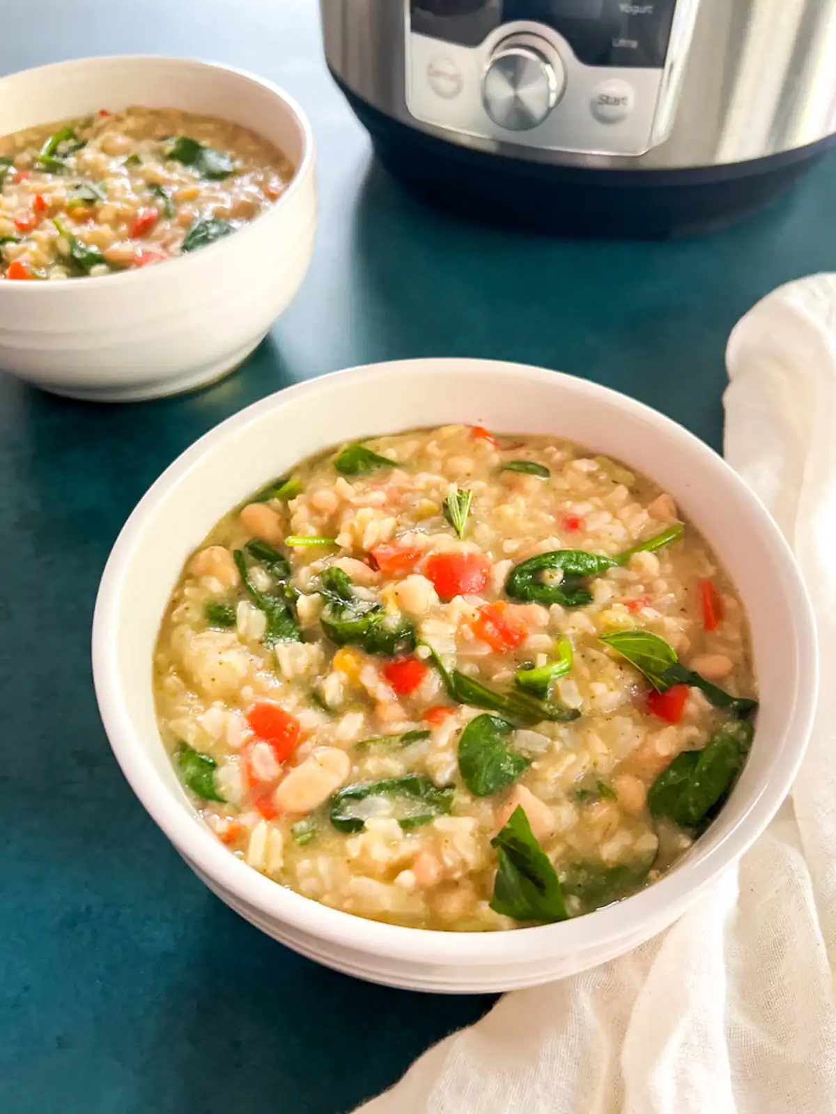 Creamy Instant Pot vegan green curry rice in white bowls.