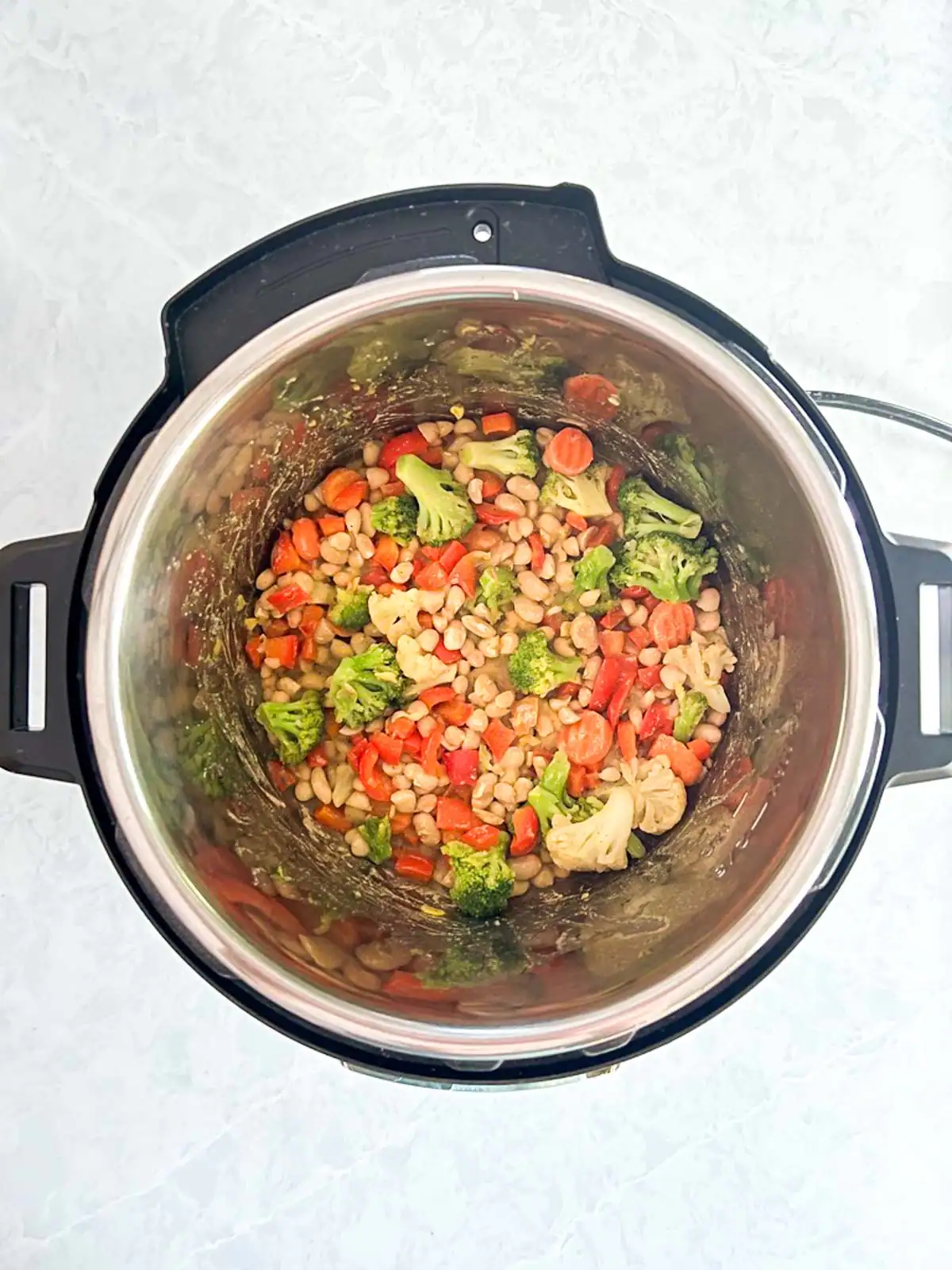 Mixed vegetables and beans in an Instant Pot.