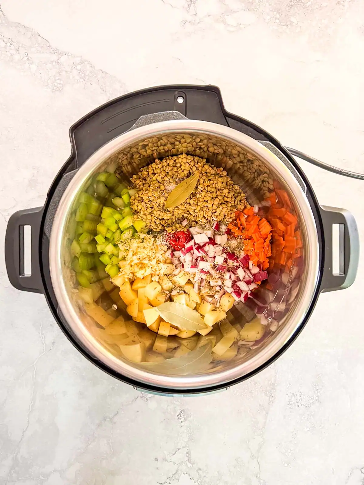 Chopped vegetables and lentils in an Instant Pot.