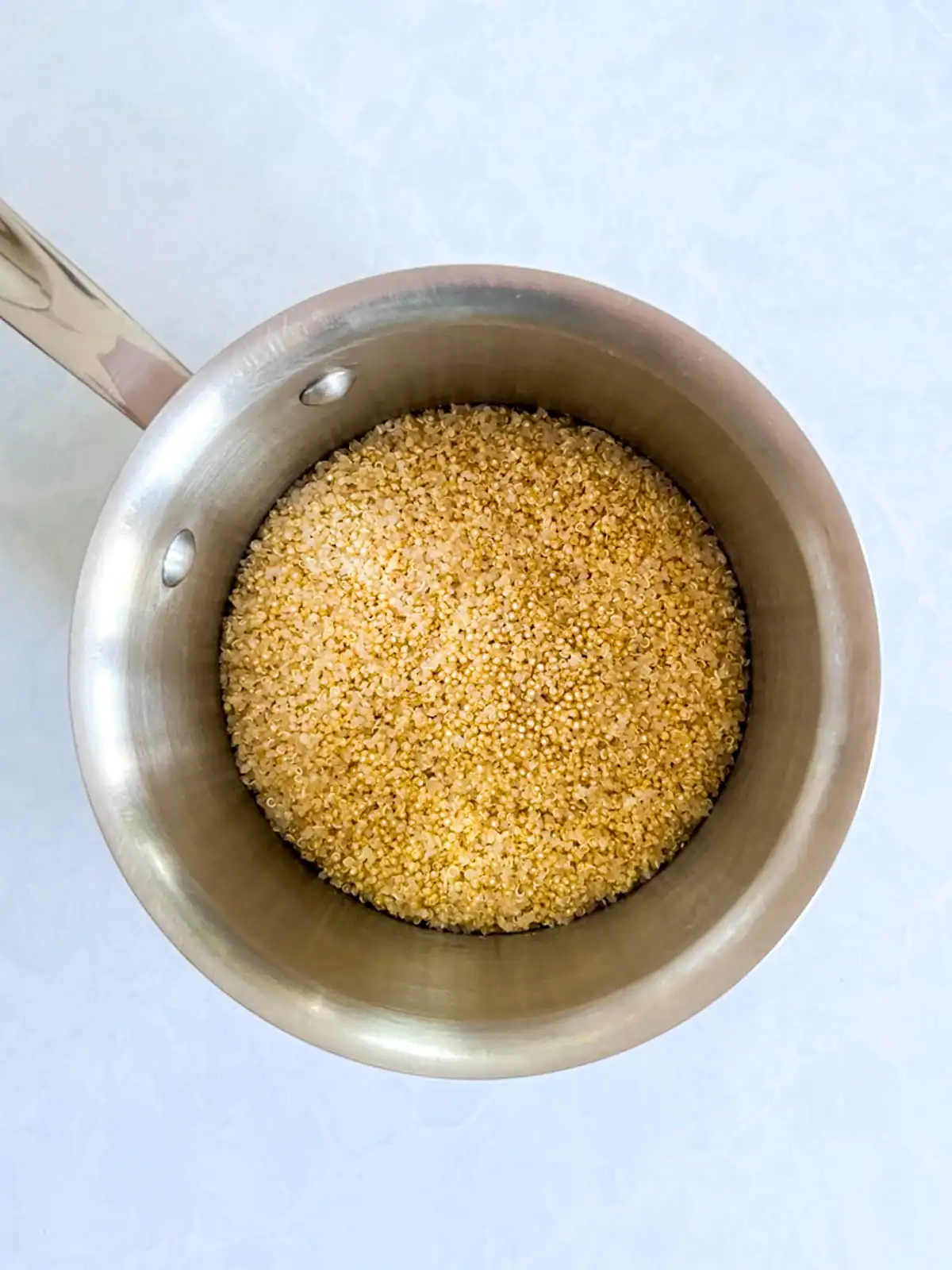 Quinoa in a stainless steel pot.