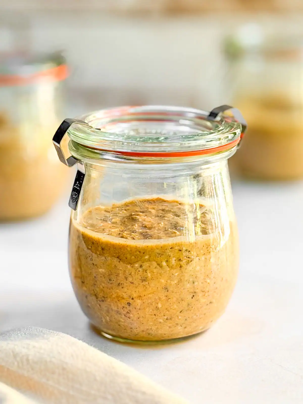 Blended pumpkin spice overnight oats in glass jars.