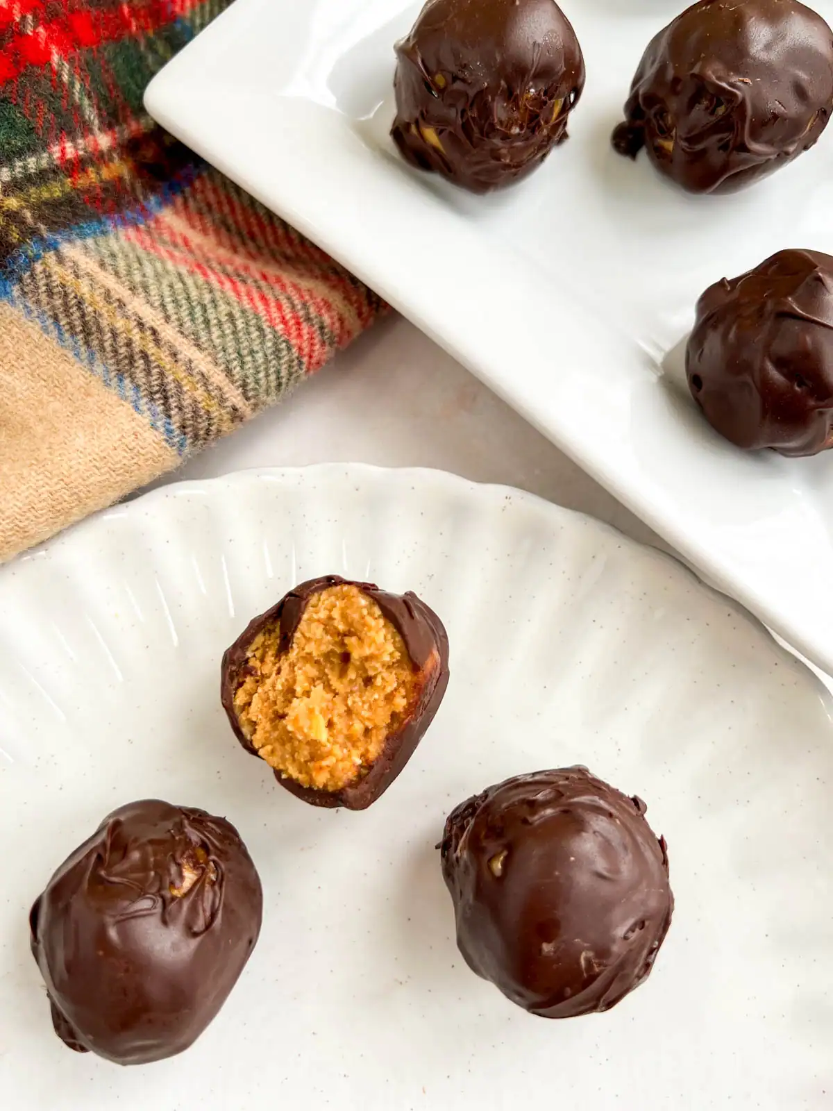 No-bake chocolate peanut butter pretzel balls with a bite taken out of one.