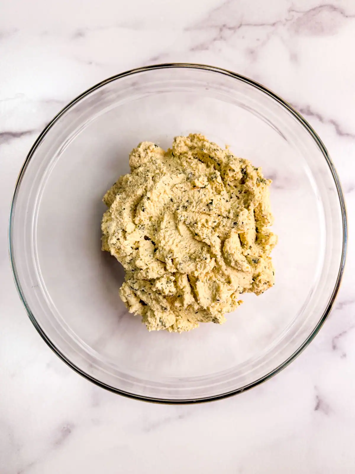 Oil-free vegan basil tofu ricotta in a glass bowl.