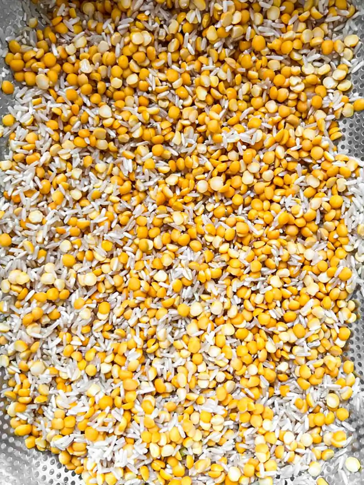 Lentils and rice in a colander.