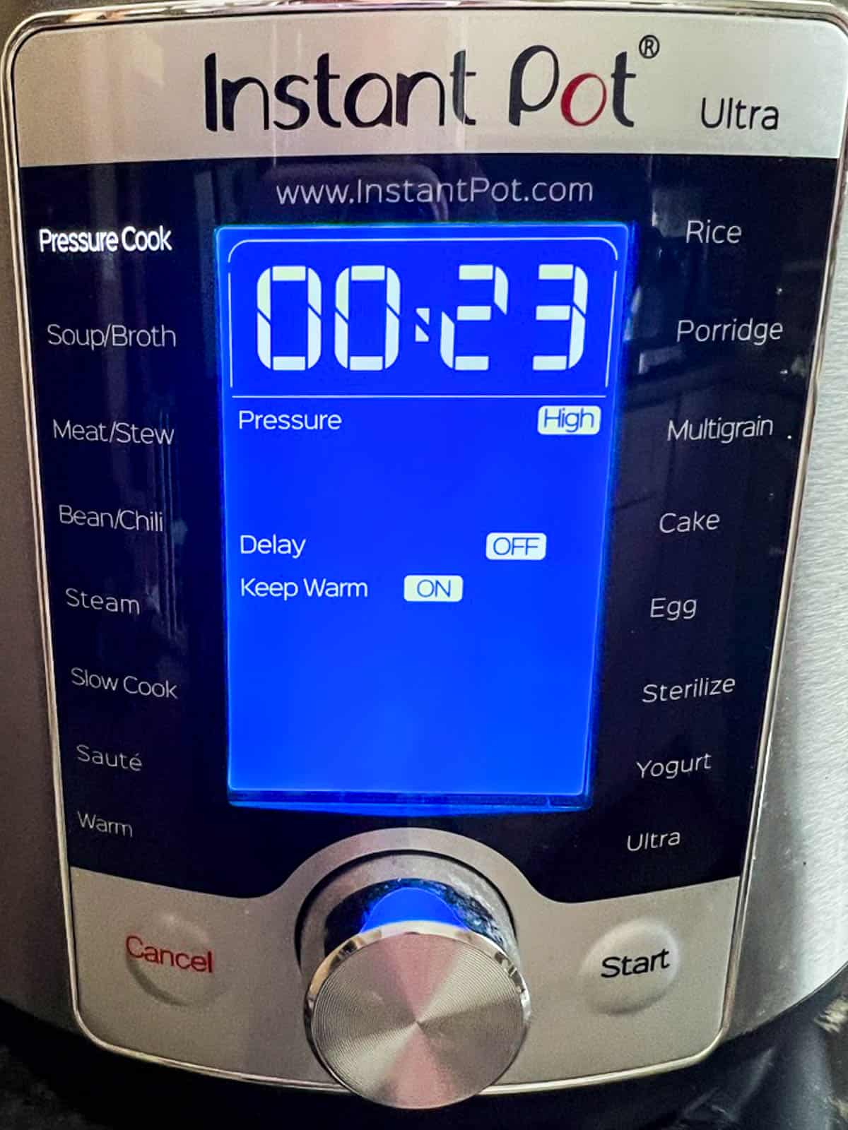 Digital display for Instant Pot set to Pressure Cook for 23 minutes on High.