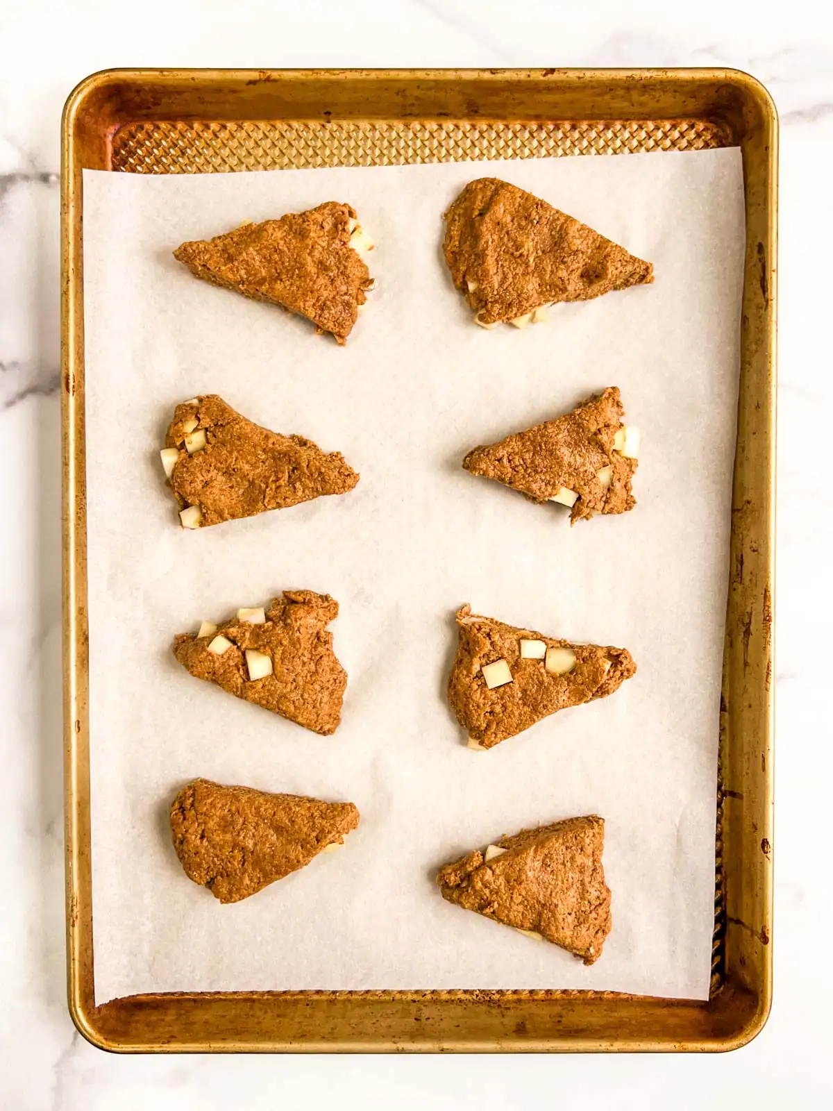 Vegan ginger scones on a baking sheet.