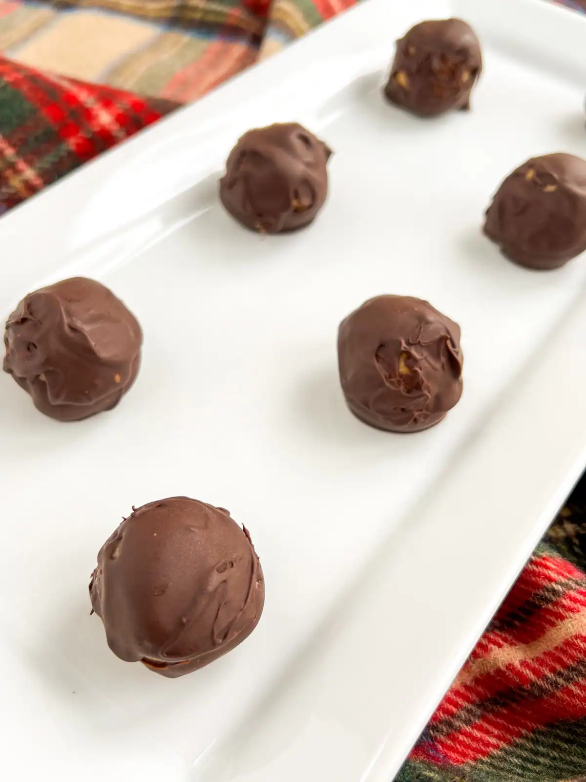 No-bake chocolate peanut butter pretzel balls on a white serving dish.