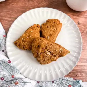 Vegan ginger pear scones on a plate next to a festive cloth.