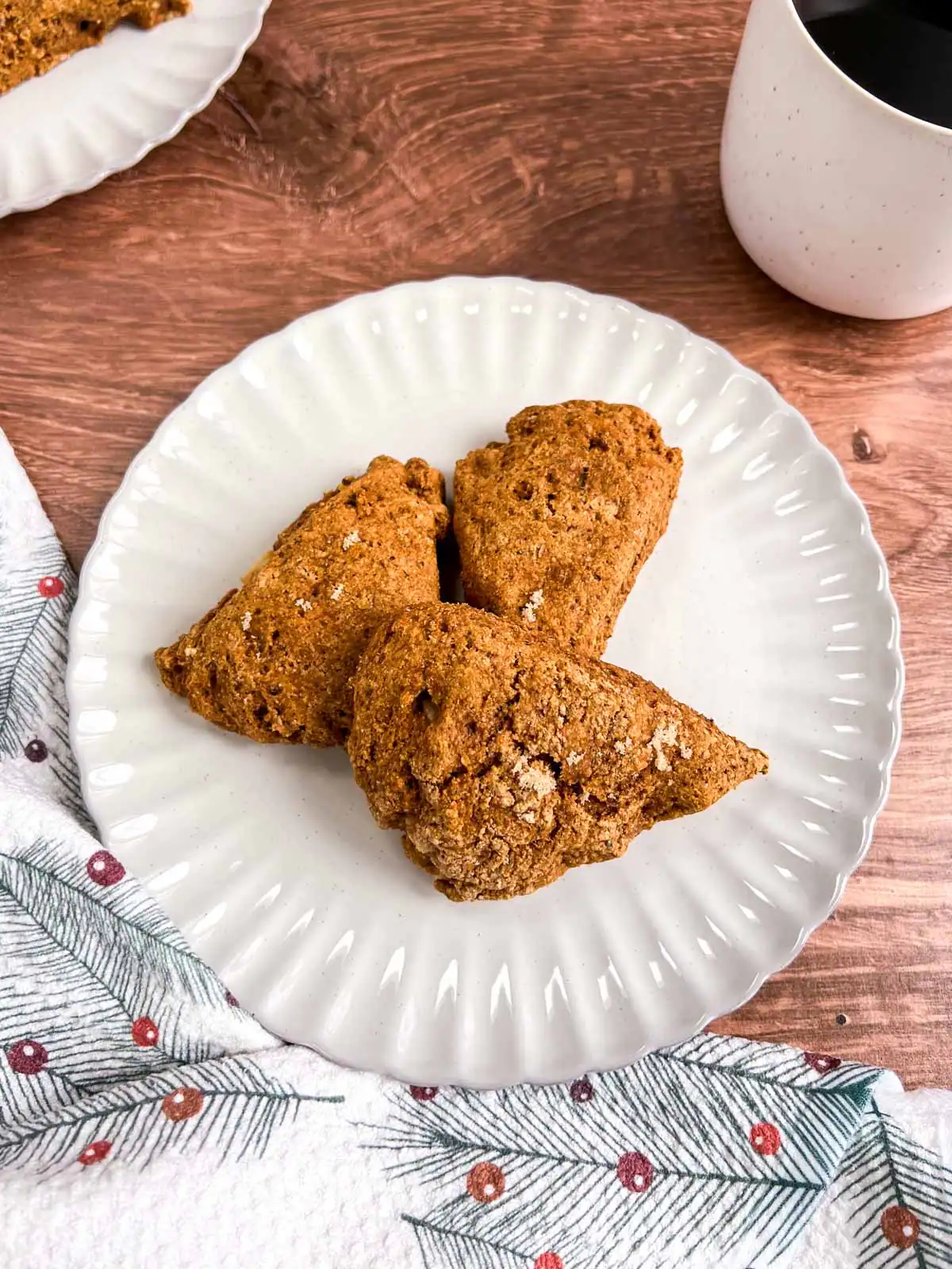 Vegan ginger pear scones on a plate next to a festive cloth.