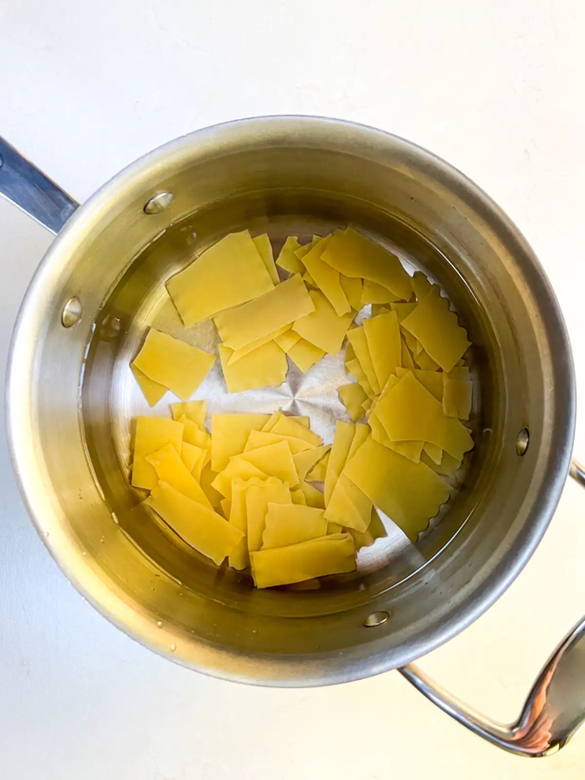 Lasagna noodles and water in a pot.