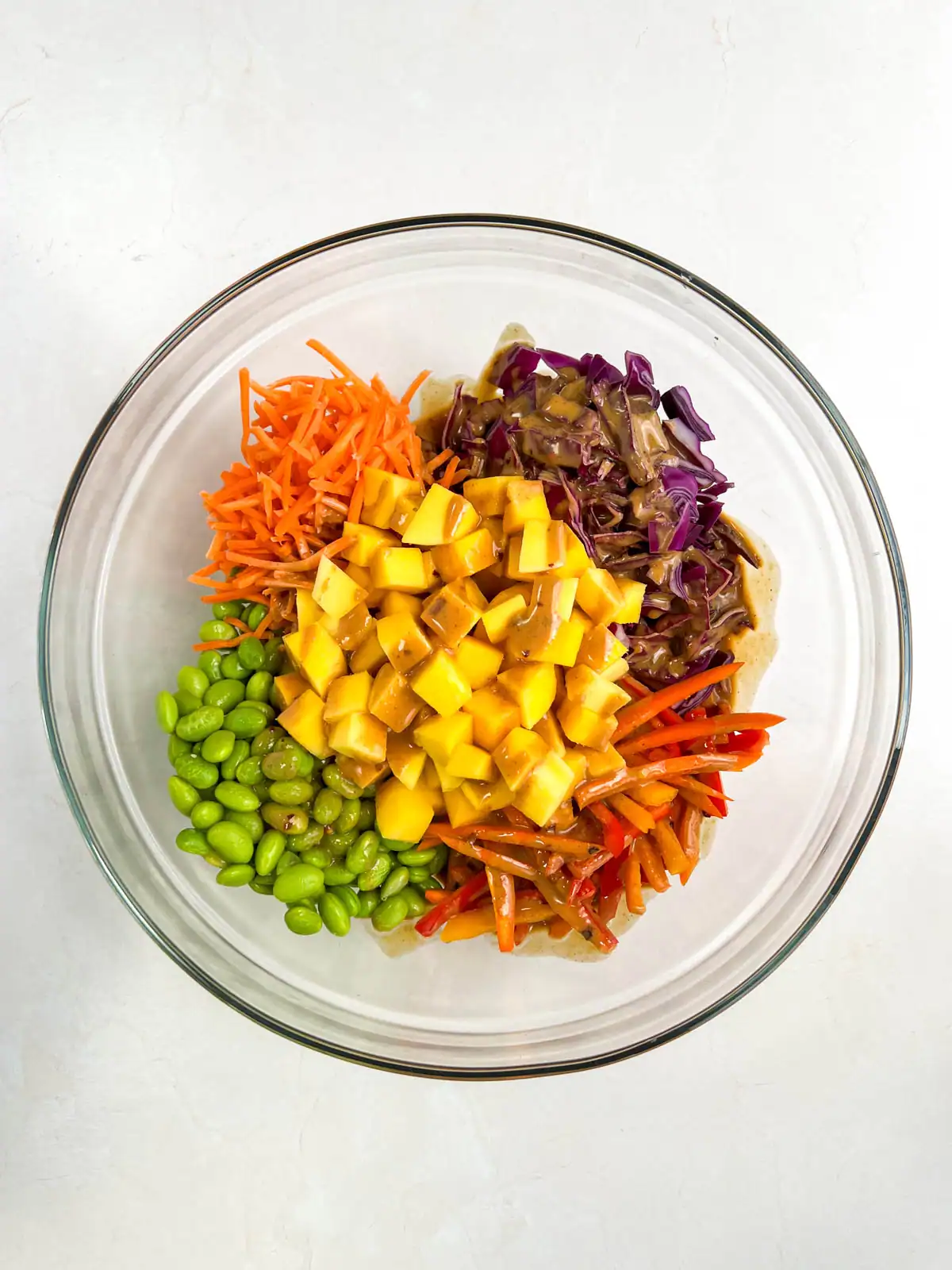 Thai peanut dressing on a colorful salad.