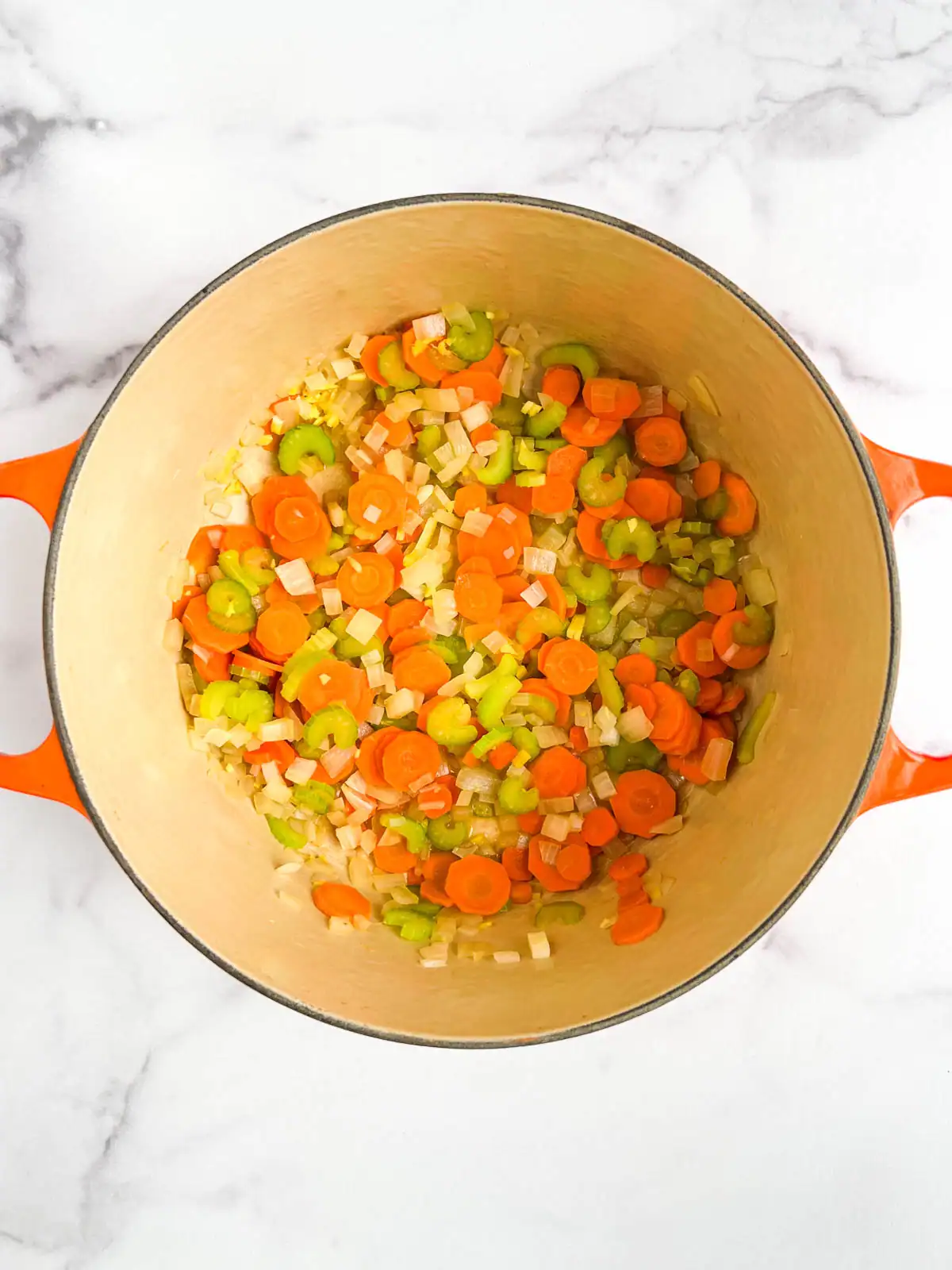 Chopped vegetables in a Dutch oven.