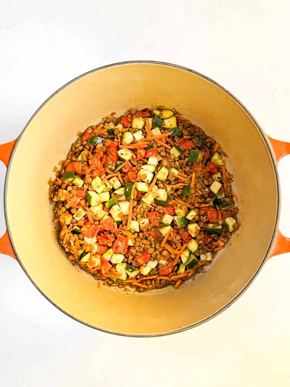Vegetables and lentils in a pot.