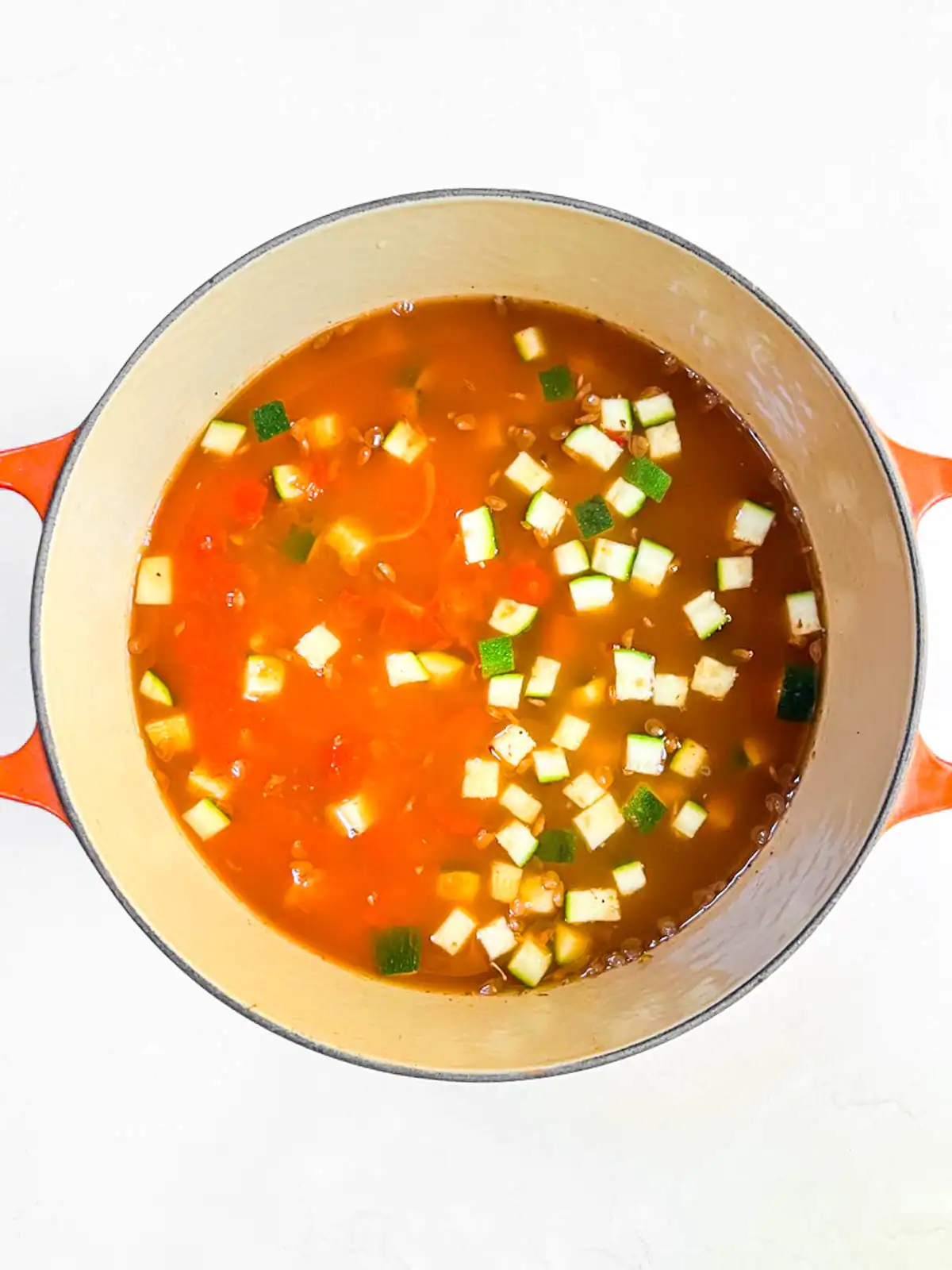 Ingredients for spicy vegan lasagna soup in a pot.