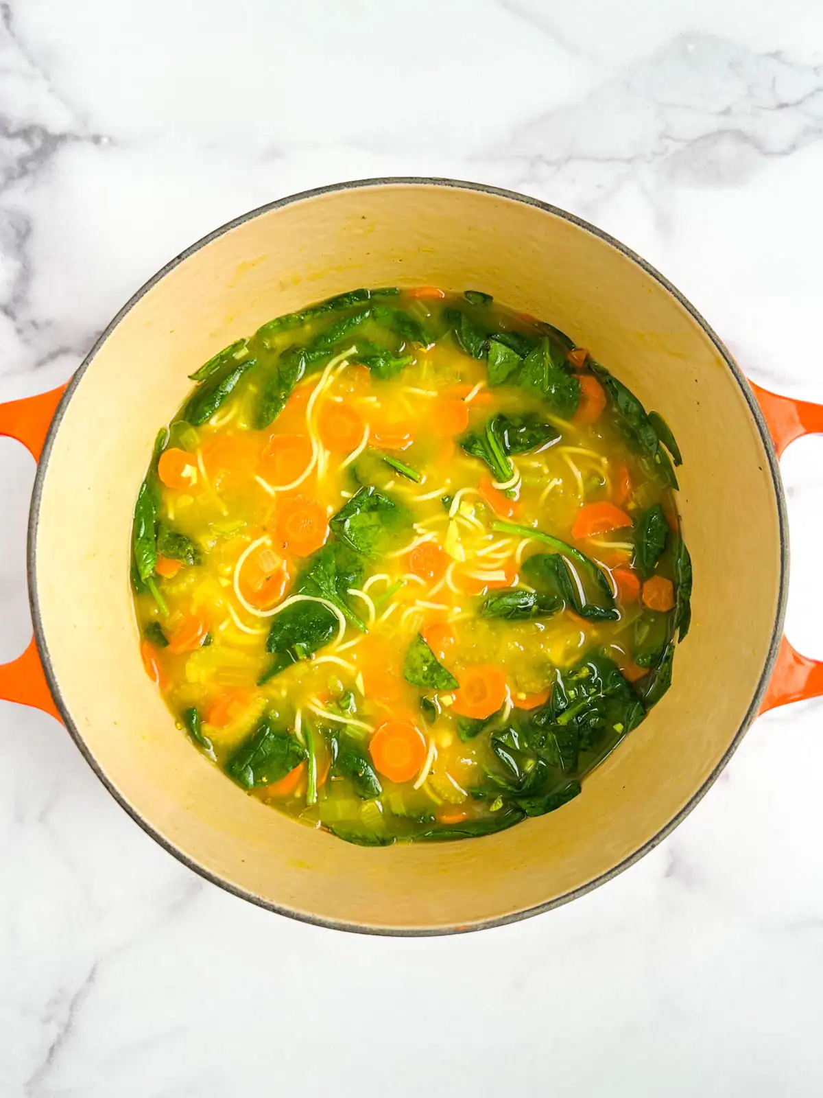 Immune-boosting vegetable soup in a Dutch oven.