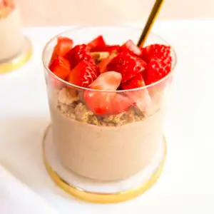 Blended strawberry overnight oats topped with fresh strawberries and graham crackers.