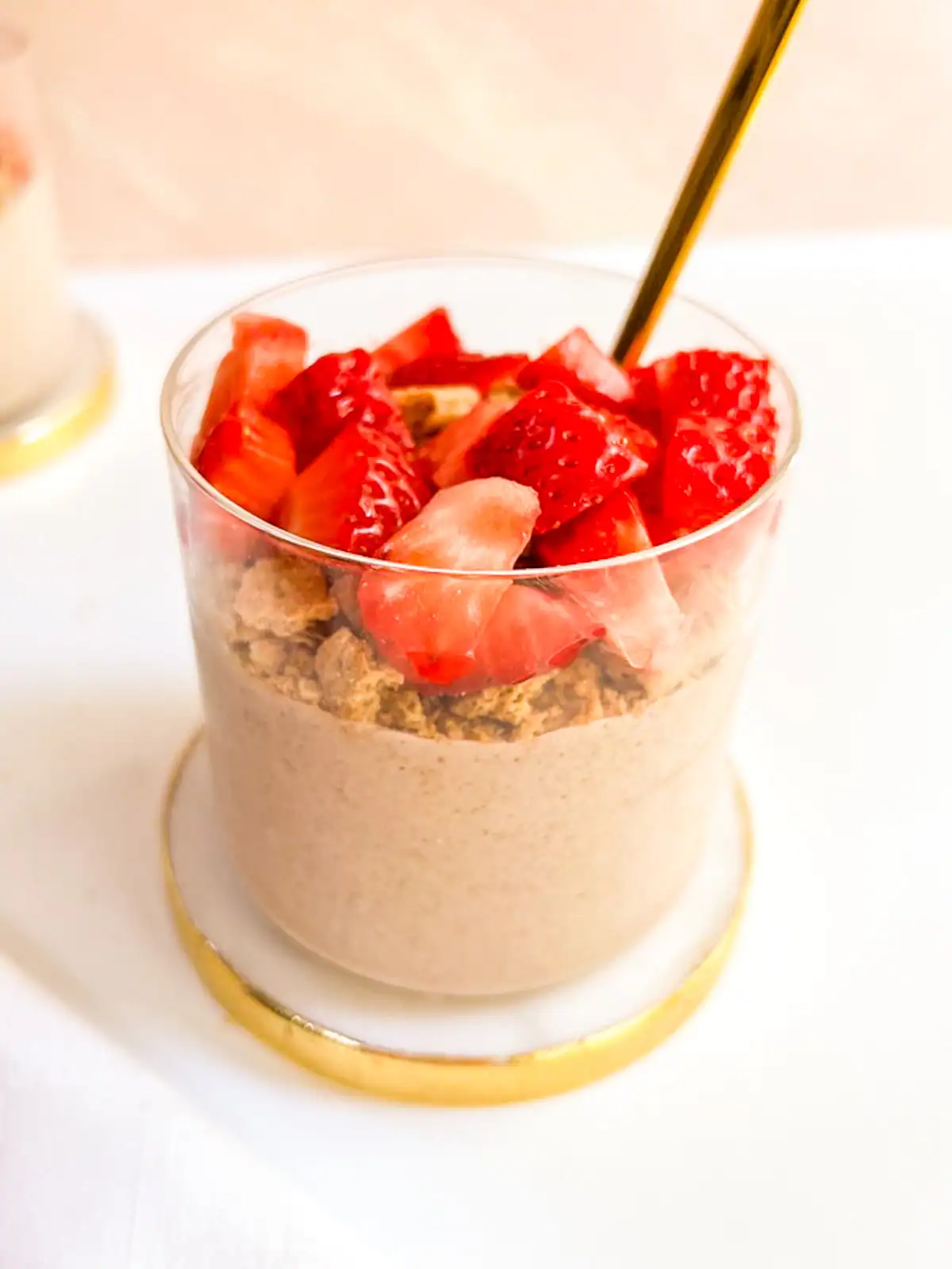 Blended strawberry overnight oats topped with fresh strawberries and graham crackers.