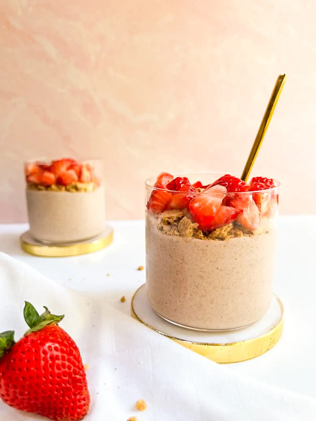 Blended strawberry overnight oats topped with fresh strawberries and graham crackers.