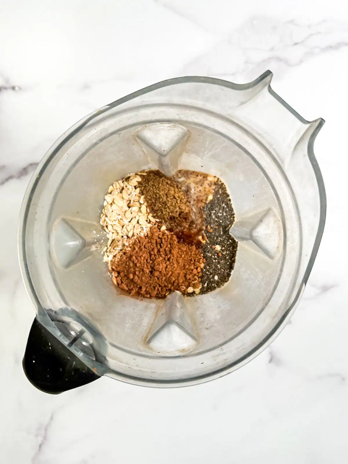 Ingredients for mint chocolate blended overnight oats in a blender.