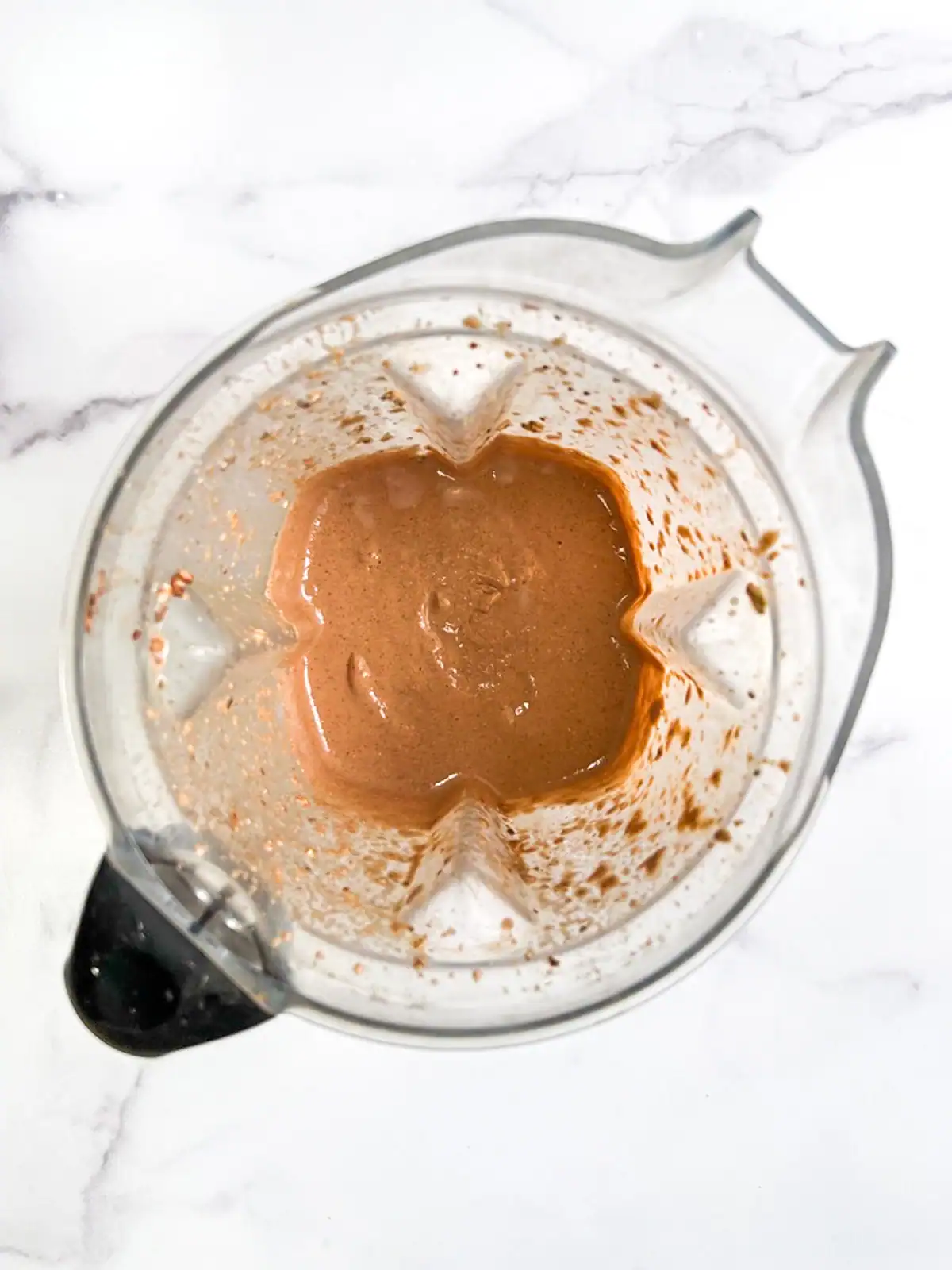 Mint chocolate blended overnight oats in a blender.