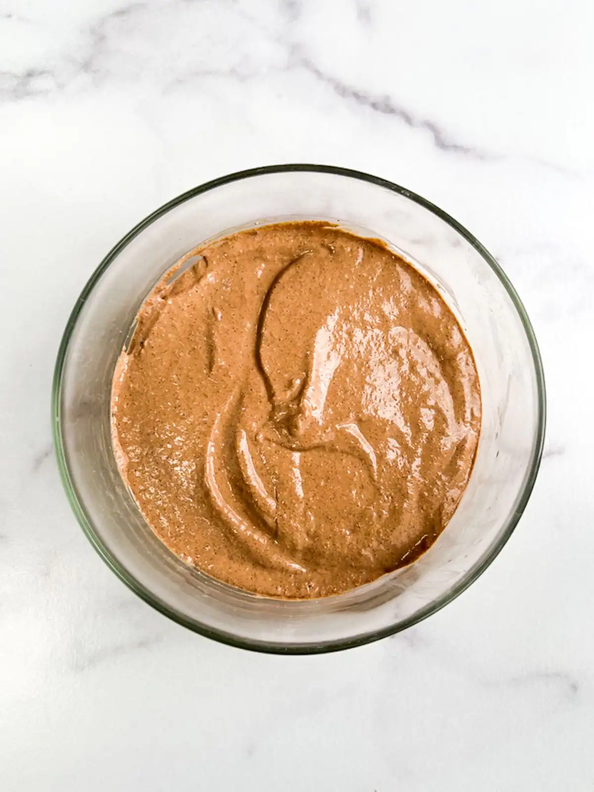 Mint chocolate blended overnight oats in a glass bowl.