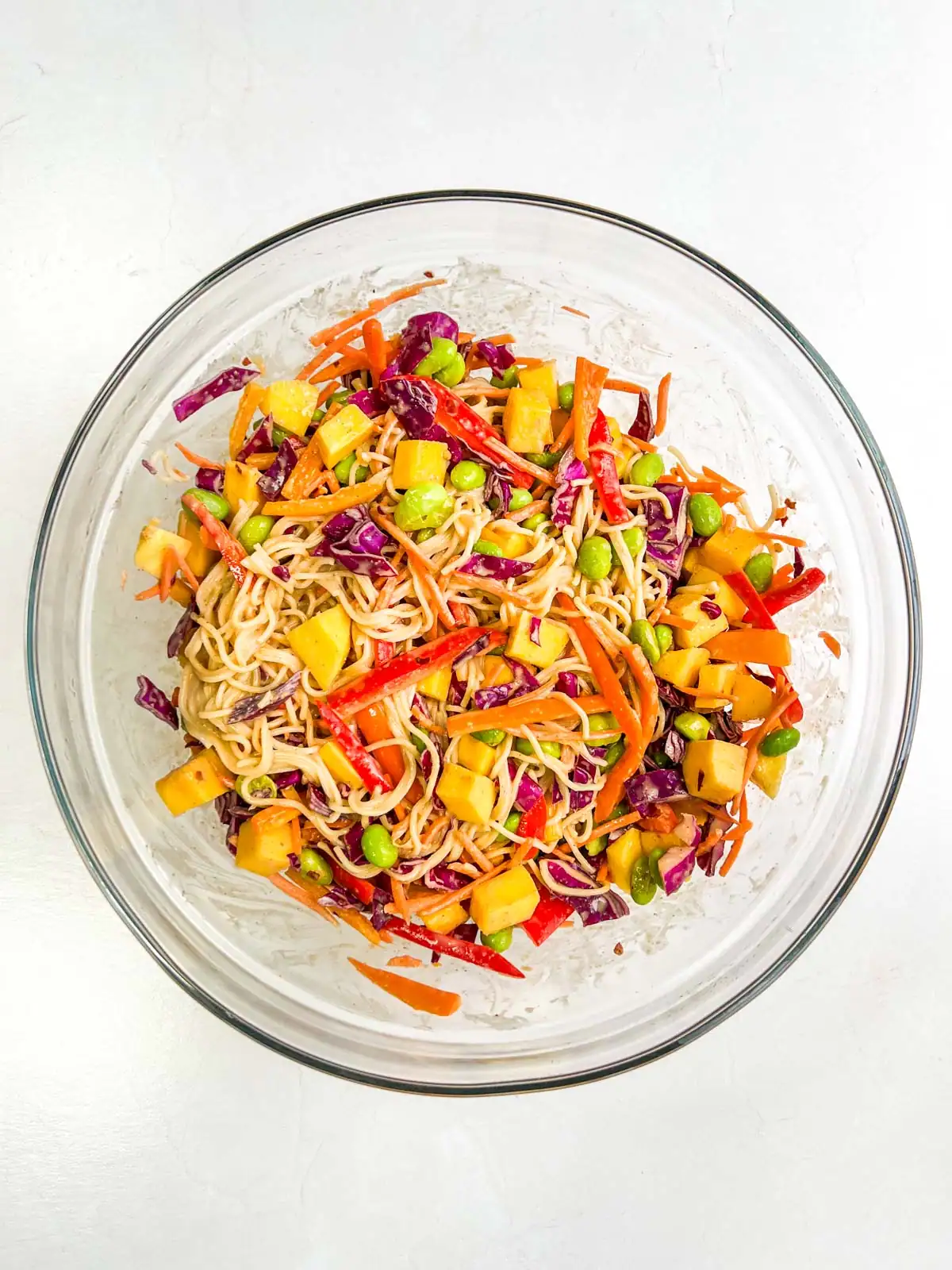 Mango peanut noodle salad in a glass bowl.