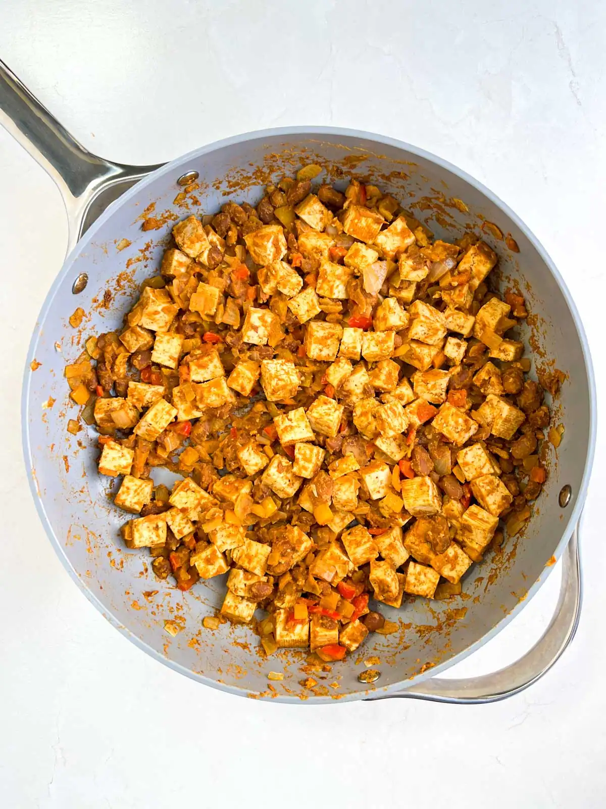 Tofu and pinto bean mixture added to skillet.