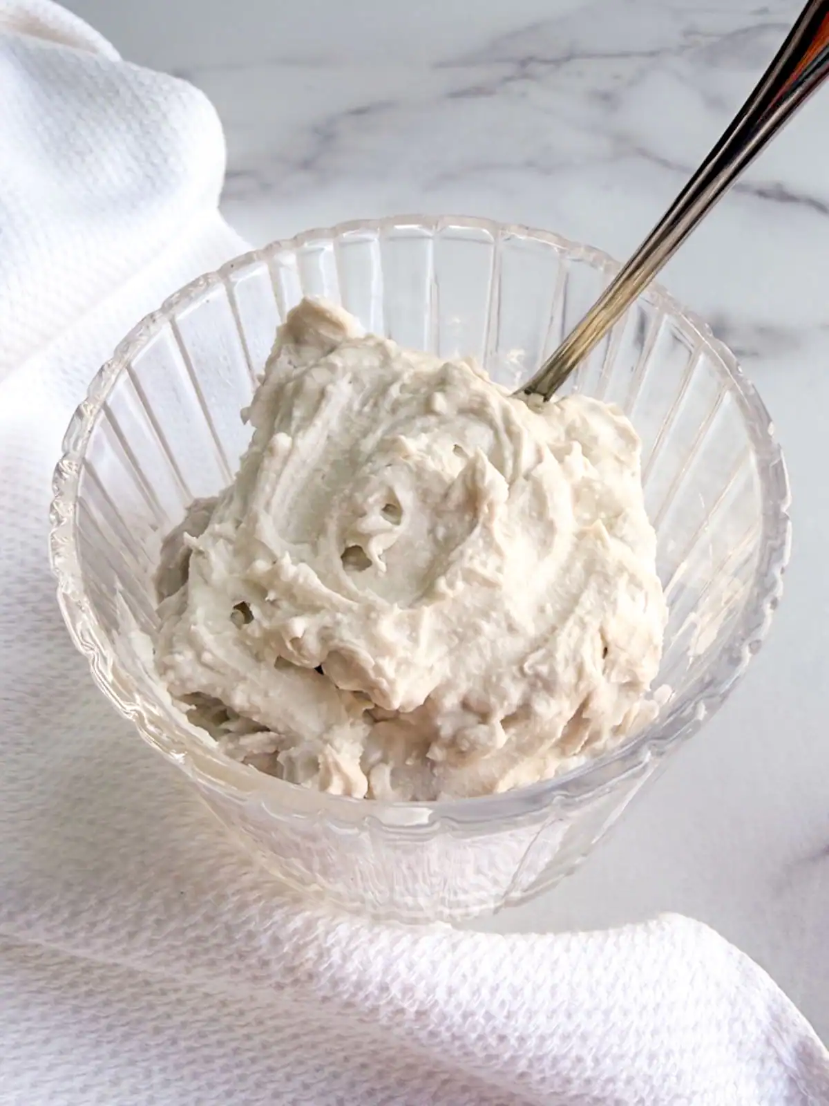 Vegan coconut whipped cream in a glass bowl.
