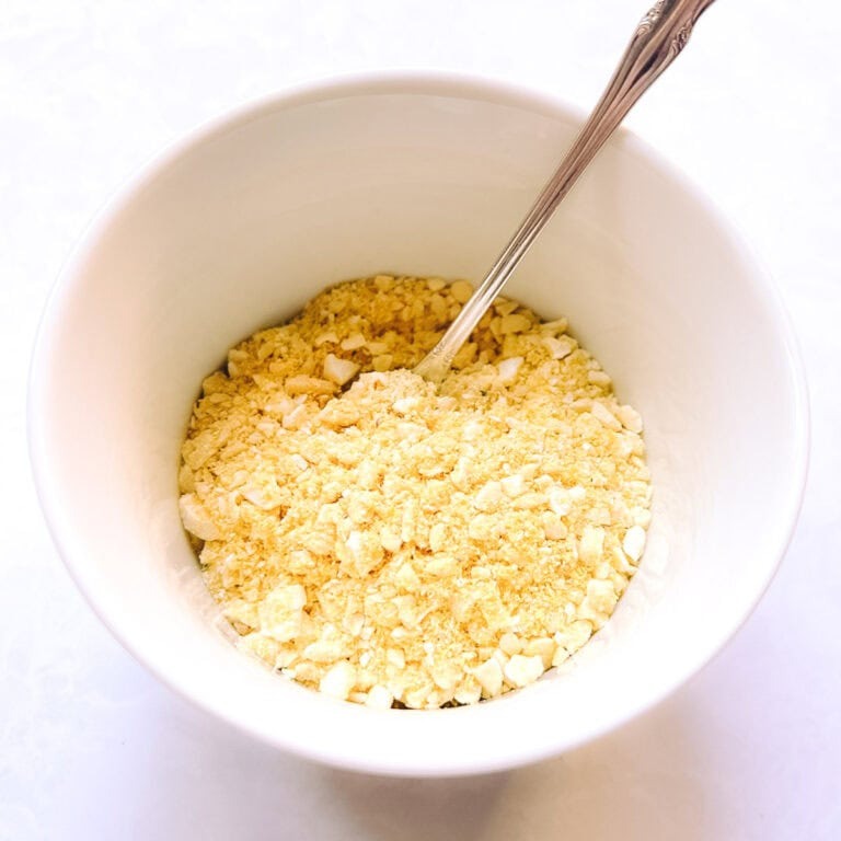 Easy vegan Parmesan cheese in a white bowl.